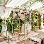 Load image into Gallery viewer, Decorative floral arrangement on a stand with a table set for a meal outdoors.
