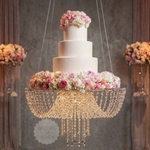 Load image into Gallery viewer, Decorative cake with flowers on a chandelier against a blurred background
