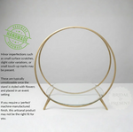 Load image into Gallery viewer, Gold circular stand with glass base on a white background, featuring a 'Handmade' label.
