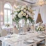 Load image into Gallery viewer, Elegant wedding reception setup with floral centerpieces and tableware in a grand room.
