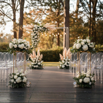 Load image into Gallery viewer, Decorative floral arrangements on a wooden pathway with clear chairs and a floral arch in the background.

Flower Stand, Wedding Centerpiece, Geometric Stand, Pedestal Stand, Floral Riser. Gold Metal Stand, Heavy Duty, Modern Wedding Decor, Event Centerpiece, Aisle Pedestal, Collapsible Stand.
