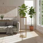 Load image into Gallery viewer, Modern living room with a gray sofa, plants, and a gold side table.

Harlow flower stand, gold wedding centerpiece stand, geometric floral riser, metal column vase, Tall centerpiece stand, wedding table decorations, heavy duty flower stand, gold pedestal stand.
