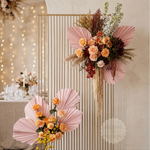 Load image into Gallery viewer, Decorative floral arrangement with pink fans and flowers on a gold stand against a neutral wall.
