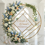 Load image into Gallery viewer, Decorative floral arch with 'Sarah &amp; David's Wedding' sign in a marble room.
