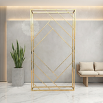 Load image into Gallery viewer, Gold geometric room divider in a modern interior setting with a plant and sofa.
