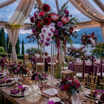 Load image into Gallery viewer, Decorative floral arrangements on a table with a scenic background
