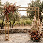 Load image into Gallery viewer, Decorative arch with flowers and pampas grass in a vineyard setting
